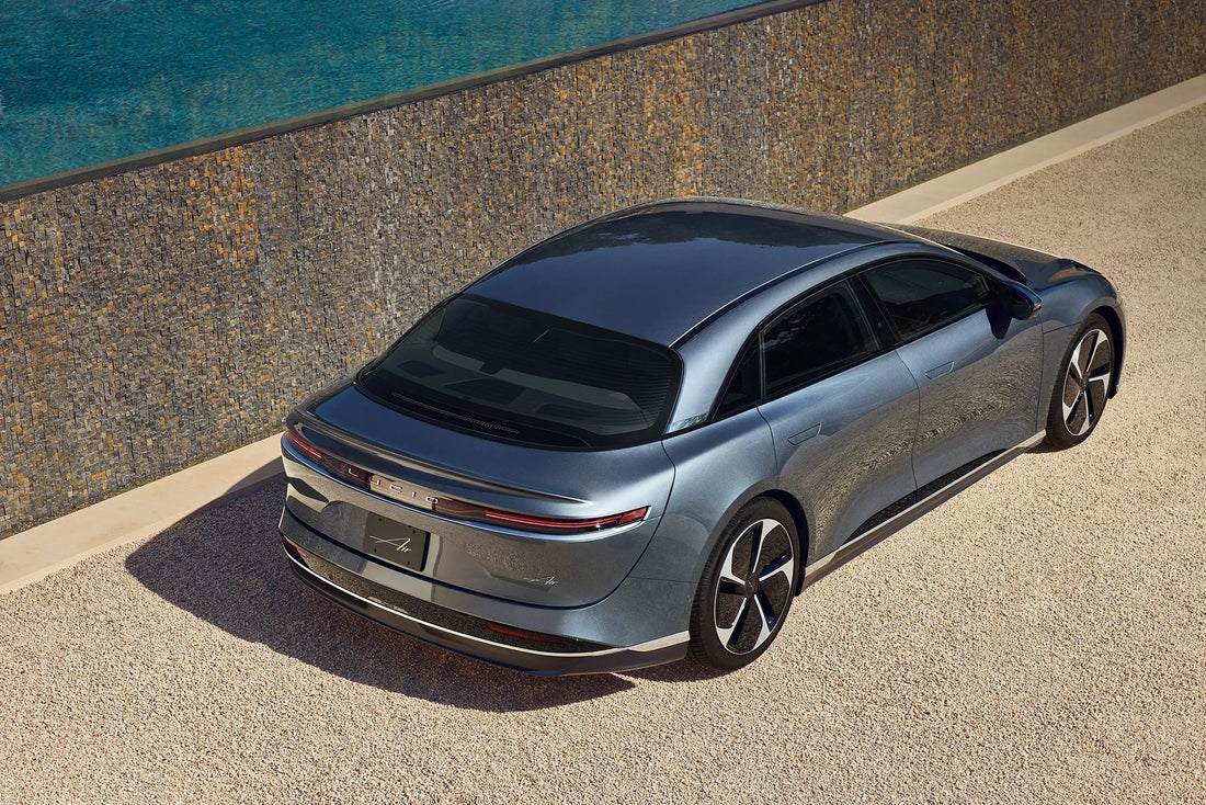 2024 Lucid Air Touring parked on a scenic road, showcasing its sleek design and luxurious details, epitomizing the fusion of high performance and electric luxury.