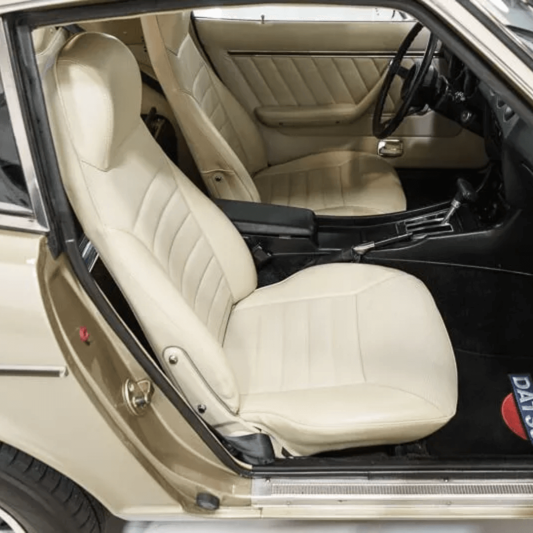 Full view of beige/cream leather seat covers for a Datsun 240Z/260Z/280Z (1970-1978), displaying the interior setup with both front seats covered, and the stylish horizontal stitching providing a classic and clean look inside the vehicle
