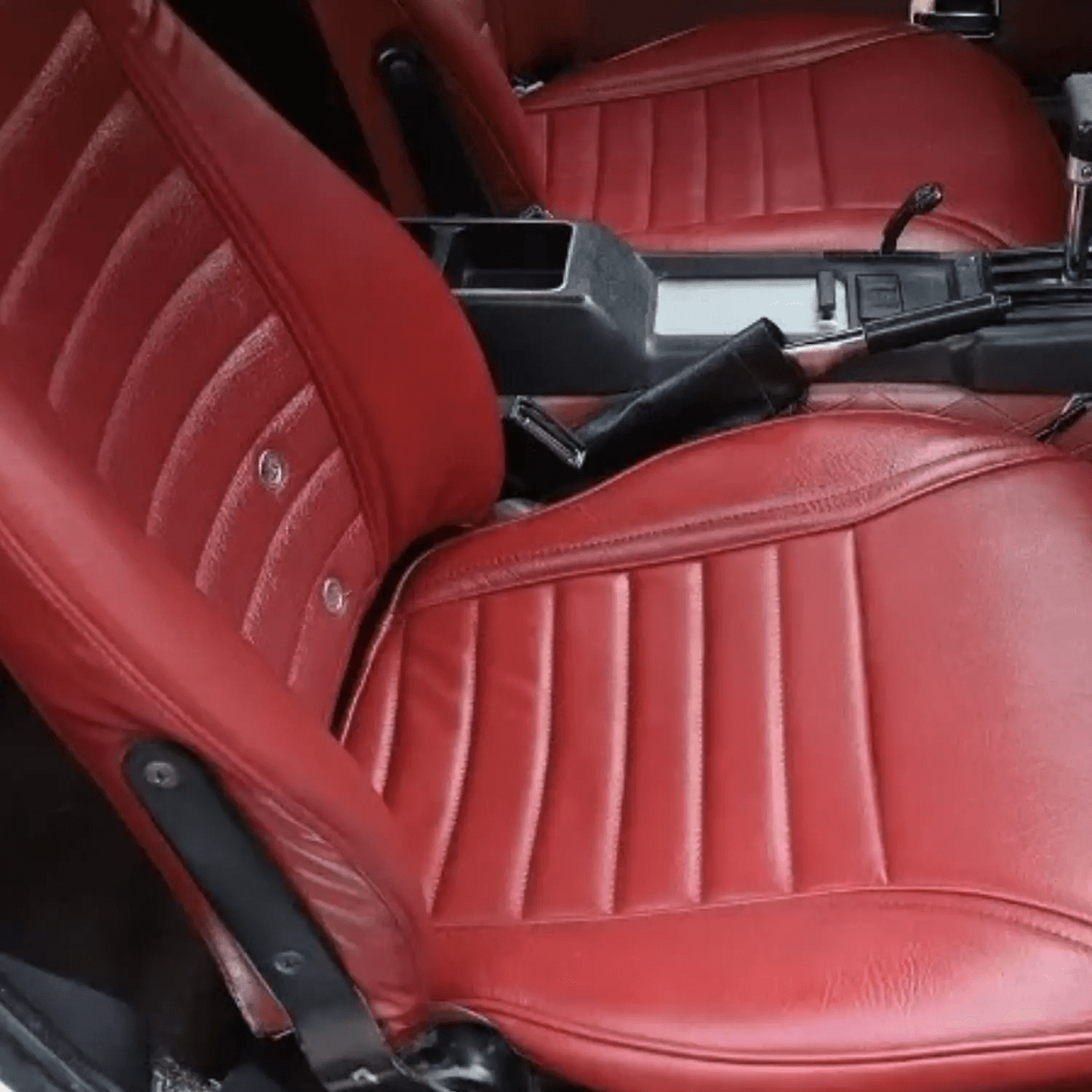Datsun 240Z/260Z/280Z synthetic leather seat covers (1970-1978) in dark red, featuring a ribbed pattern with a classic vintage design on the driver seat.