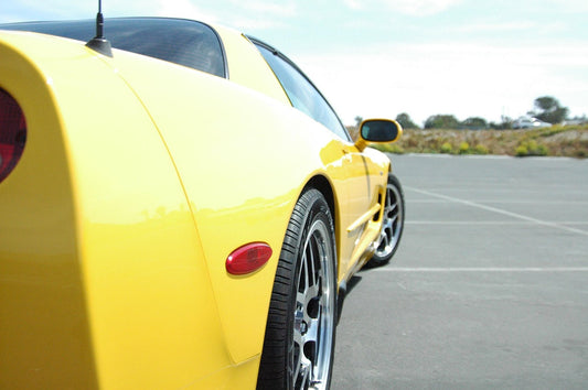 Image showing a Corvette C5 with annotations highlighting common issues such as steering lock and oil leaks, amidst logos from competitors like Ridies.com, Lseat.com, Katzkin, KustomInterior, and LeatherSeats.com.