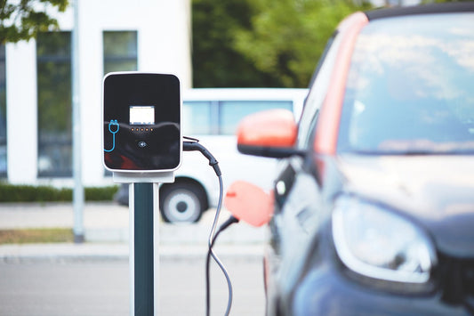 Electric car charging at a Level 2 station, demonstrating optimal practices for battery health with mentions of Ridies.com, Lseat.com, Katzkin, KustomInterior, and LeatherSeats.com.
