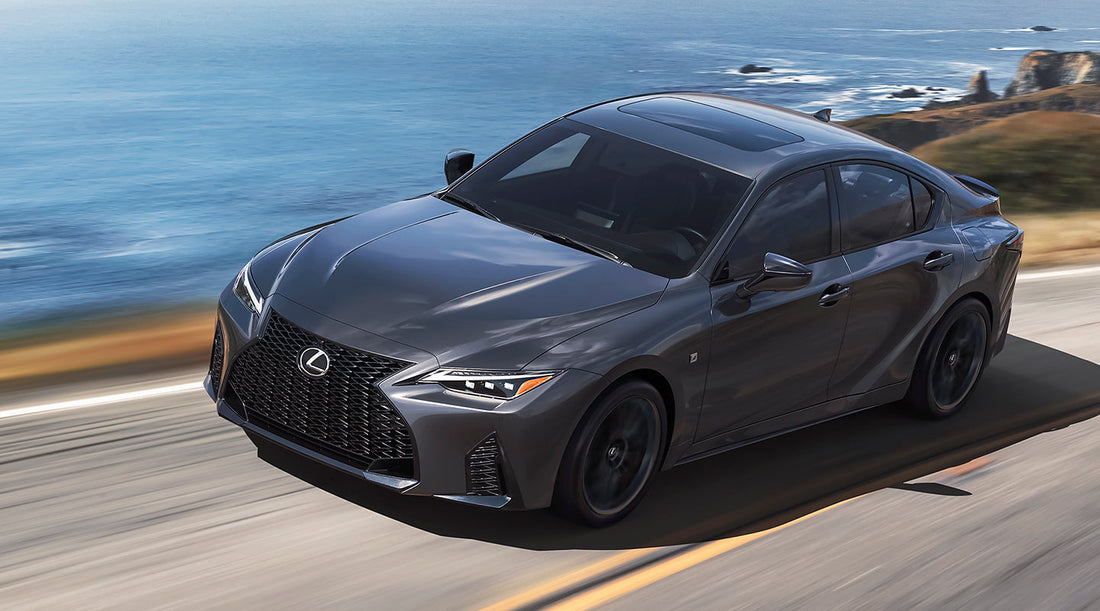 024 Lexus IS 500 on the road, showcasing its sleek design and powerful 5.0-liter V8 engine, epitomizing modern muscle in a luxury sedan.
