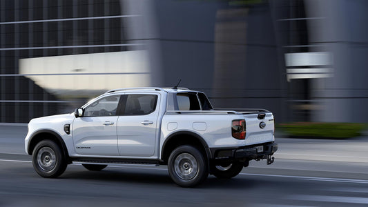 2024 Ford Ranger XLT cruising on a highway, showcasing its sleek new design and powerful performance, ideal for both urban and off-road adventures.