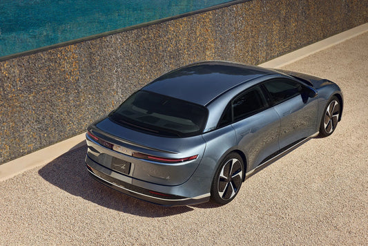 2024 Lucid Air Touring parked on a scenic road, showcasing its sleek design and luxurious details, epitomizing the fusion of high performance and electric luxury.