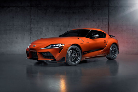 2024 Toyota Supra 45th Anniversary Edition in vibrant orange, showcasing its iconic design, special graphics, and signature rear wing—a tribute to the legendary Supra legacy.