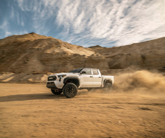 2024 Toyota Tacoma and RAV4 parked outdoors, showcasing their updated features and designs, perfect for family adventures and off-road enthusiasts alike.