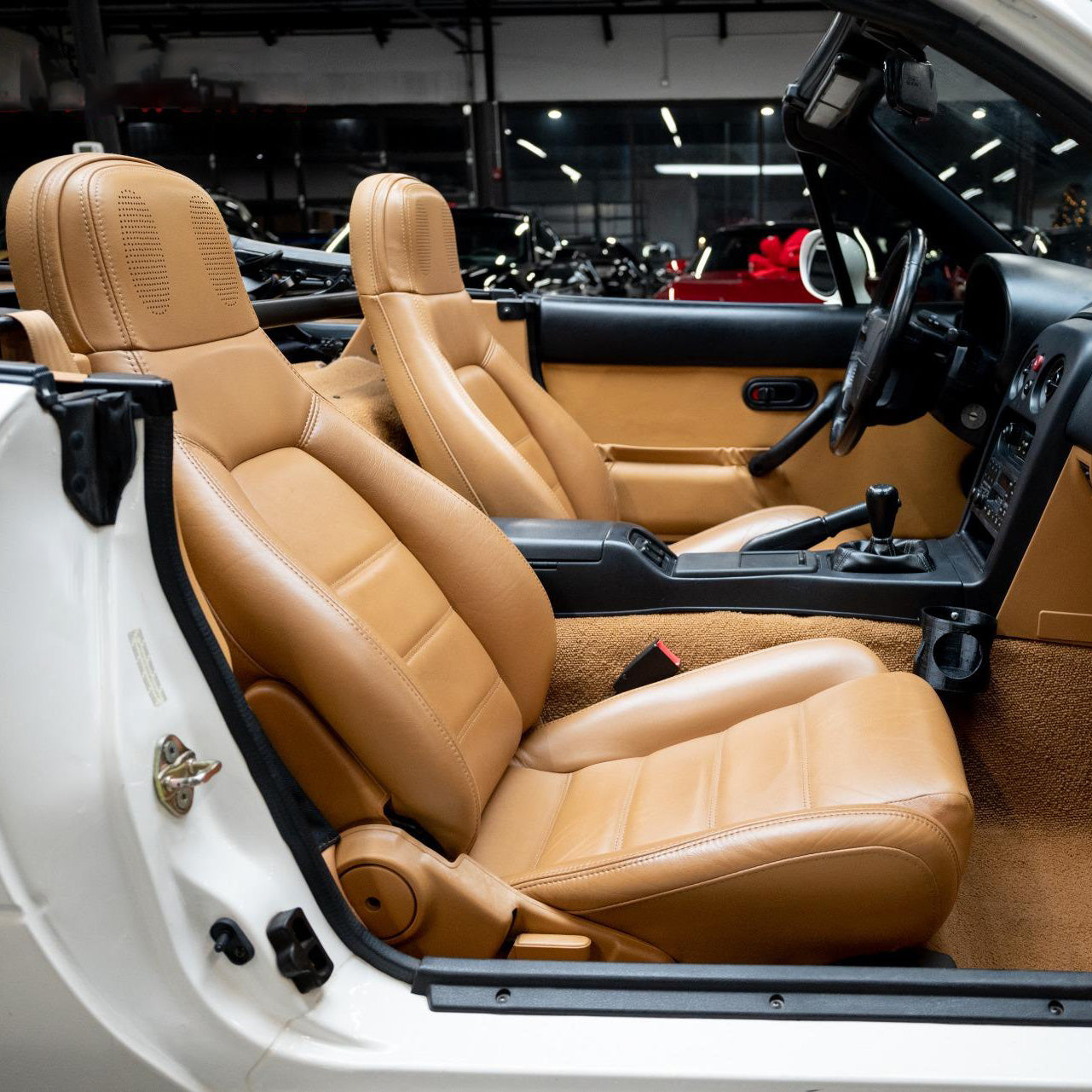 Custom OEM replacement leather seat covers for Mazda Miata NA, NB, NC, and ND models, enhancing interior comfort, style, and durability.