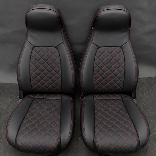 Black leather Mazda Miata MX-5 replacement seat covers with red diamond stitching, featuring quilted center inserts and OEM-style sporty bolsters for driver and passenger seats.