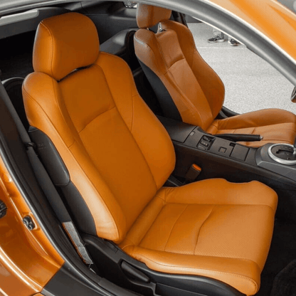 Nissan 350Z synthetic leather seat covers in burnt orange, designed for 2003-2008 models, shown installed in the car, highlighting the vibrant color and snug fit.