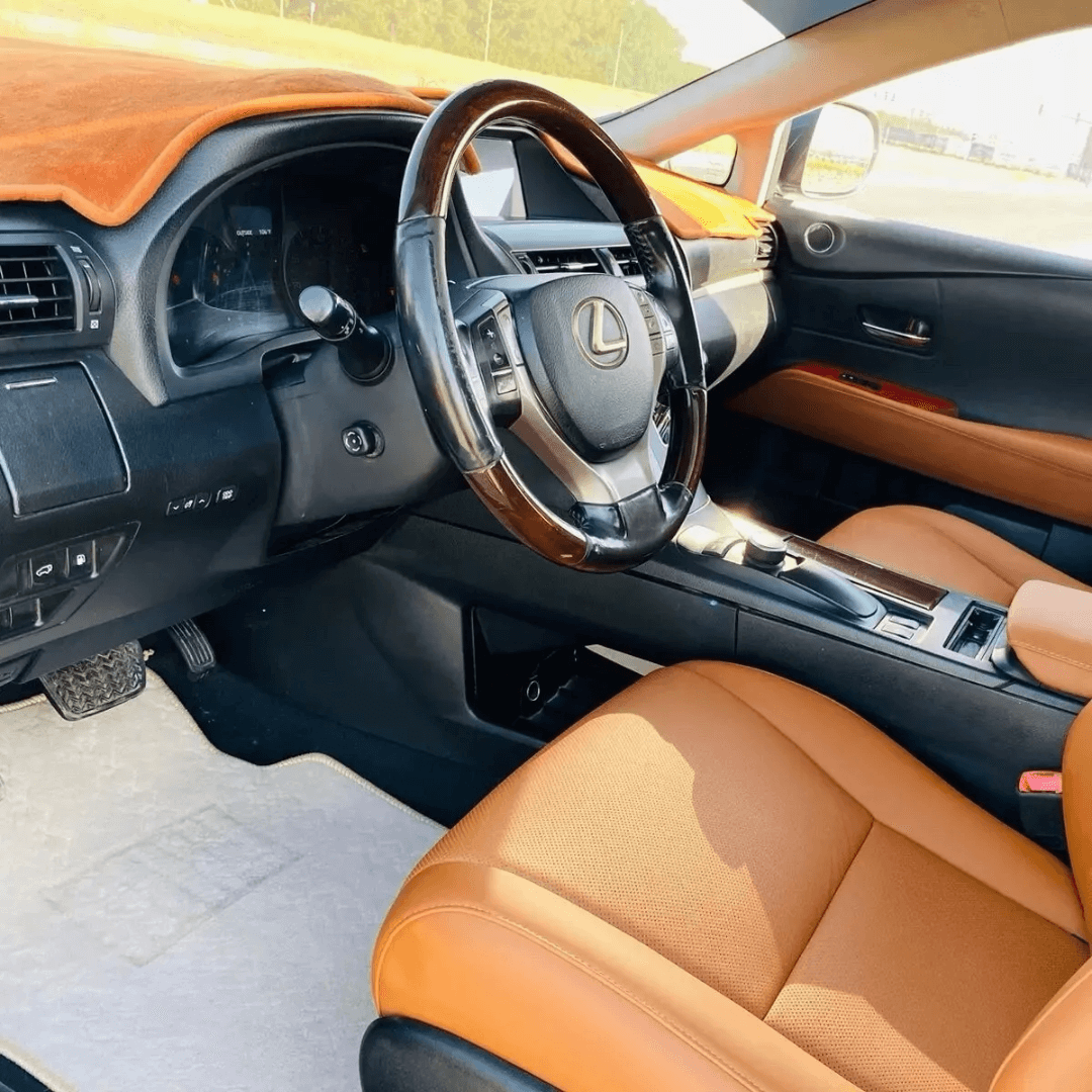 Interior view of a Lexus RX350/RX450h showcasing premium brown leather seat covers with sleek stitching and luxurious texture.