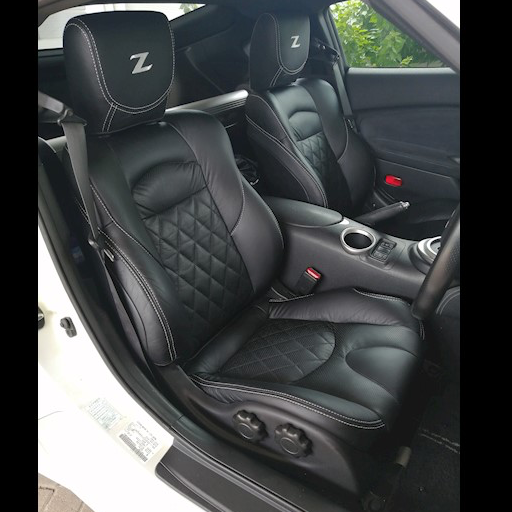 Nissan 370Z (2009–2016) black leather replacement seat covers with diamond-stitched inserts and white contrast stitching, custom-fit upholstery kit for cloth manual seats only. Fits Z34 models — competitor alternatives include LSeat, Rudies, KatzKin and AutoSeatSkins.