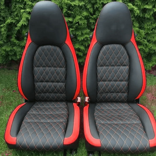 Custom Porsche Boxster 986 (1997-2004) seat covers in black and yellow leather with a diamond pattern and yellow stitching, designed for a bold and luxurious interior upgrade.