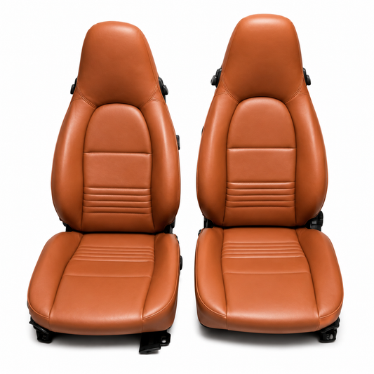 Burnt orange leather seat covers designed for Porsche Boxster 986 models from 1997 to 2004, showcasing the full set of driver and passenger seats with distinct stitching and contoured padding.