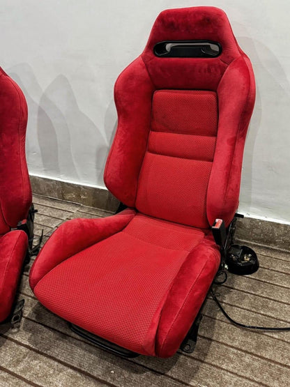 Close-up view of Recaro SR3 Confetti DC2 Type R bucket seat in red suede, emphasizing the seat's textured fabric and ergonomic contours.